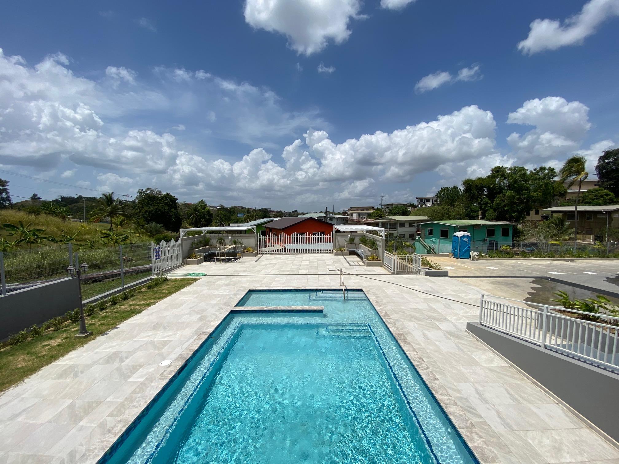 City Heights San Fernando apartment building Trinidad — modern high-rise with parking and scenic views